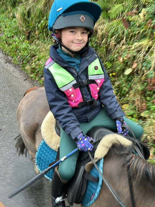EquiLight Mini Pro Rider Vest with integrated rechargeable LED lighting and reflective detailing, hi-vis safety vest designed for young riders to improve visibility and confidence in low-light conditions
